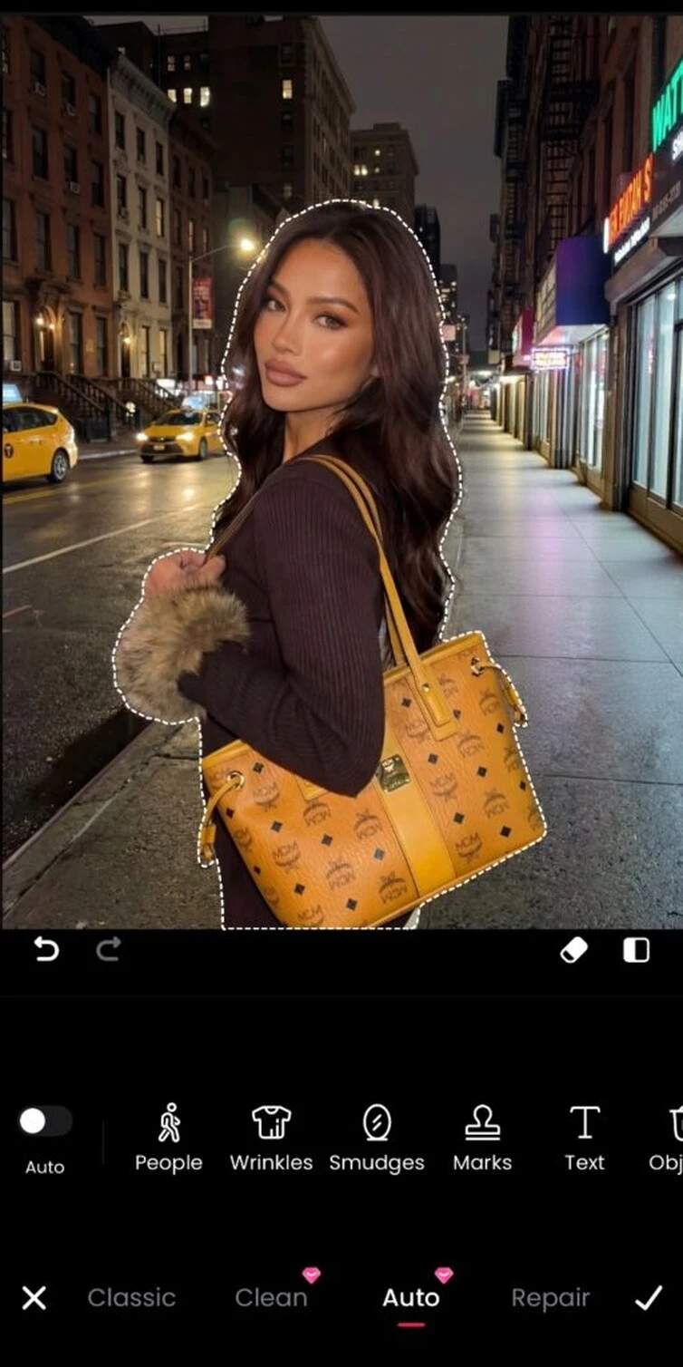 Meitu showing the photo after the selected background visitor has been removed.