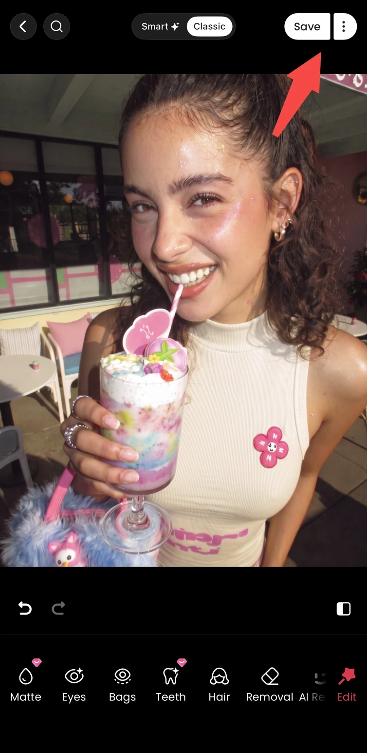 Confirming teeth edits in Meitu and saving the finished smiling portrait.